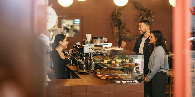 Business Pathways Couple Chatting in Cafe in Wellington