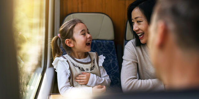 Family Pathways Mother and Daughter Laughing Together on a Train Ride Through Canterbury